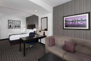 a hotel room with a bed and a couch and a desk at La Quinta by Wyndham Austin - Cedar Park in Cedar Park +33 photos