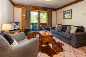 a living room with a couch and a table at Ginabelle 14 apartment - Chamonix All Year in Chamonix-Mont-Blanc