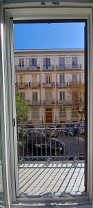 a window with a view of a large building at Casa Pinello in Palermo