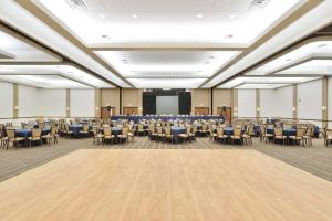 a large room with tables and chairs and a podium at The Lismore Hotel Eau Claire - a DoubleTree by Hilton in Eau Claire