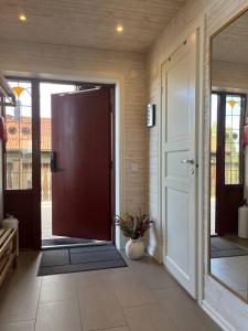 an open door of a house with a porch at Alpstigen 6B - 6 bäddars fjällstuga mitt i Järvsöbacken in Järvsö