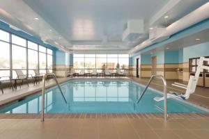 a swimming pool with tables and chairs in a building at Hampton Inn by Hilton Elko Nevada in Elko
