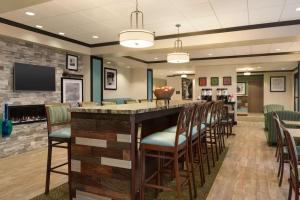 a bar in a restaurant with chairs and a fireplace at Hampton Inn by Hilton Elko Nevada in Elko