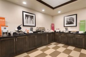 a kitchen with wooden cabinets in a room at Hampton Inn by Hilton Elko Nevada in Elko