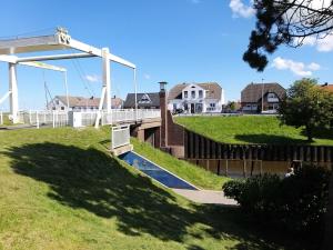a skate park with a bridge over a river at Pension Restaurant Zur Brücke in Carolinensiel