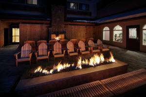 a group of chairs sitting around a fire pit at Highline Vail - a DoubleTree by Hilton in Vail