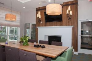 a dining room with a table and a fireplace at Hilton Garden Inn Springfield in Springfield