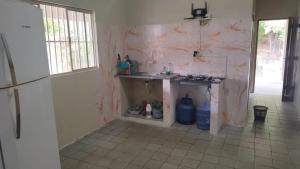 a kitchen with a counter and a sink in a room at VARANDA LENÇÓIS in Barreirinhas