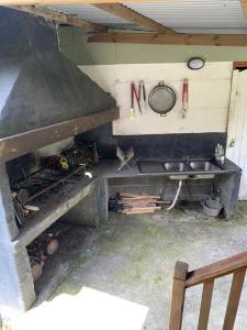 an outdoor kitchen with a sink and a stove at Les Châlets du Medinilla in La Plaine des Palmistes