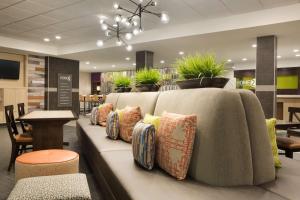 a couch with pillows on it in a lobby at Home2 Suites by Hilton Houston Webster in Webster