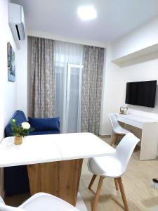 a living room with a white table and chairs at Navarino Luxe Suites in Perea