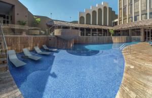 a large swimming pool with chairs in a building at Doubletree By Hilton Iquitos in Iquitos