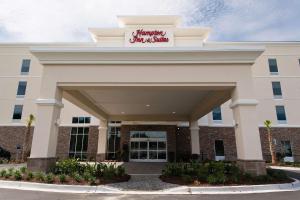 a building with a sign on top of it at Hampton Inn and Suites Fayetteville, NC in Fayetteville