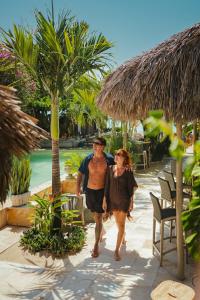 um homem e uma mulher a andar por um resort em Casa na Praia em Jericoacoara