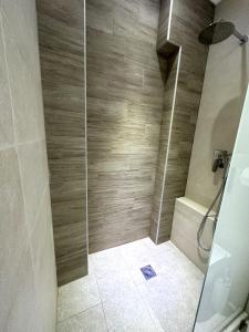 a shower with a glass door in a bathroom at Navarino Luxe Suites in Perea