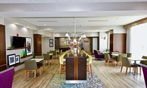 a dining room with a table and chairs at Hampton Inn By Hilton Kirksville MO in Kirksville