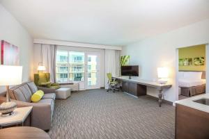 a hotel room with a couch and a desk at Hilton Garden Inn Ft. Walton Beach in Fort Walton Beach