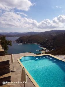 a swimming pool with a view of a body of water at Villa Real Paradise Kalamos Evia in Trikovilón