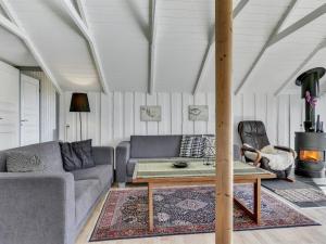 a living room with a couch and a table at Holiday Home Katrina - 50m to the inlet in SE Jutland by Interhome in Broager