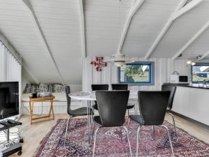 a dining room with a table and chairs at Holiday Home Katrina - 50m to the inlet in SE Jutland by Interhome in Broager