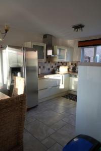 a kitchen with a stainless steel refrigerator at Cosy Stirling 3-bedroom Home in Stirling
