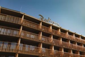 a building with a sign on top of it at Radisson Hotel Szklarska Poręba in Szklarska Poręba