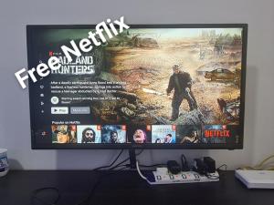 a computer monitor sitting on top of a desk at The Simplicity Homestay in Tanah Rata
