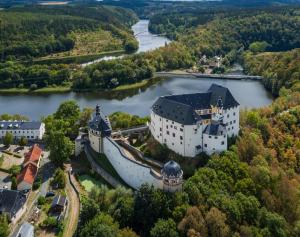 an aerial view of a castle on a river at Landhauswohnung am Thüringer Meer mit Whirlpool-Fühlen wie Zuhause 