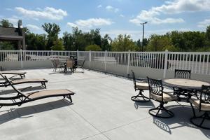a patio with tables and chairs and a fence at Quality Inn & Suites Red Wing in Red Wing