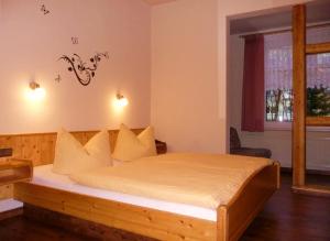 a bedroom with a bed with white sheets and a window at Pension Haus Flora in Oberhof