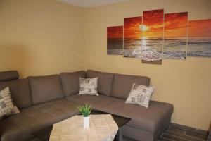 a living room with a couch and a table at Hafenperle Carolinensiel in Carolinensiel