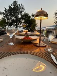 a table with wine glasses and a plate of food at Kalkan Port Hotel in Kalkan