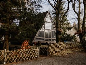a house behind a fence with a window at Holiday Home Hexenhaus im Harz by Interhome in Clausthal-Zellerfeld +19 photos