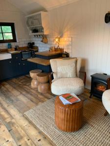 a living room with a chair and a coffee table at The Deerstone Luxury Eco Hideaway in Laragh