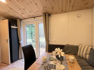 a living room with a table and a couch at Holiday Home Soul & Forest by Interhome in Wemding
