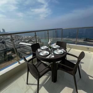 a table and chairs on a balcony with a view at Sky-high Villa فيلا عنان السماء in Jeddah +31 photos