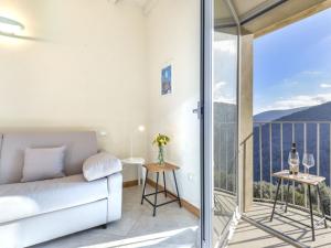 a living room with a couch and a balcony at Apartment Sant'Agabito by Interhome in Marciana