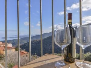 two wine glasses and a bottle of wine on a table at Apartment Sant'Agabito by Interhome in Marciana