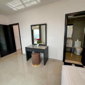 a bathroom with a vanity and a sink and a mirror at Sky-high Villa فيلا عنان السماء in Jeddah