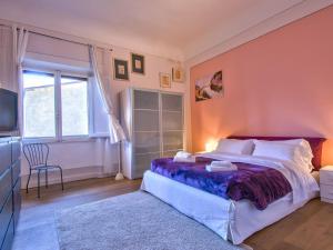a bedroom with a large bed and a window at Apartment Bellevue Palazzo Pitti by Interhome in Florence