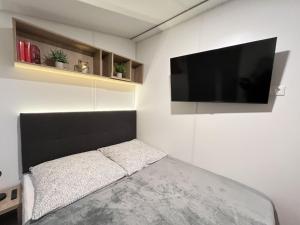 a bedroom with a flat screen tv on the wall at Holiday Home Seeblick by Interhome in Wemding