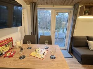 a dining room table with wine glasses on it at Holiday Home Seeblick by Interhome in Wemding