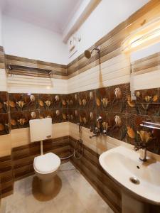 a bathroom with a toilet and a sink at HOTEL JVS PALACE in Gorakhpur +96 photos