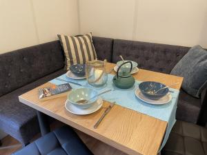 a table with plates and bowls on a couch at Holiday Home Soul & Lake by Interhome in Wemding