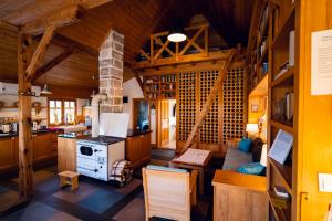 a kitchen and living room with a stove in a cabin at Seosko turisticko domacinstvo Radivojevic in Čačak