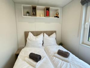 a bedroom with a bed with two towels on it at Holiday Home Tiny Haus Rotkehlchen by Interhome in Riedenburg