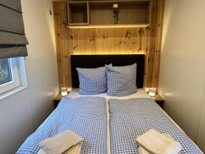 a bedroom with a bed with blue and white pillows at Holiday Home Paul by Interhome in Wemding
