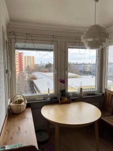 a room with a table and a window with a view at Sunny ROOM in Stockholm in Stockholm