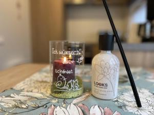 a candle and a bottle of lotion on a table at Holiday Home Renate by Interhome in Wemding