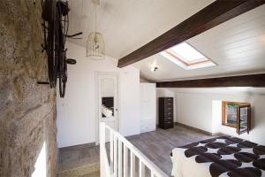 a bedroom with a bed and a skylight at Casa Nova in Carnota